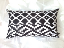 Load image into Gallery viewer, Sharp and bold 14 x 24 African fabric pillow cover. Boast vibrant black and white geometric shapes and is made from 100% cotton.
