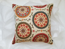 Load image into Gallery viewer, Boho-Retro inspired pillow cover, main colour is cream with beautiful multi-coloured circles (burnt oranges, green, red, tangerine, and turquoise) lined with flowers and stems. 20 x 20 inches made from mixed fibers.  
