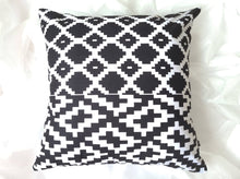 Load image into Gallery viewer, Sharp and bold 20 x 20 African fabric pillow cover. Boast vibrant black and white geometric shapes and is made from 100% cotton.
