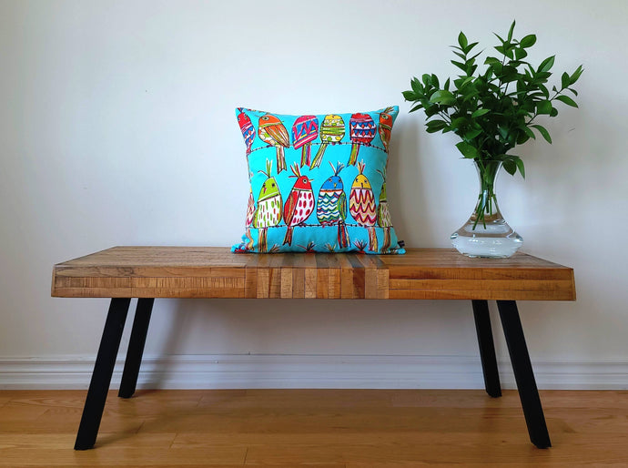 Blue cotton 20 x 20 inch, vibrant pillow cover with multi coloured birds perching on a wire, fun, fresh, and bold.