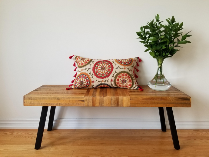 Boho-Retro inspired pillow cover lines with tassels , main colour is cream with beautiful multi-coloured circles (burnt oranges, green, red, tangerine, and turquoise) lined with flowers and stems. 14 x 24 inches made from mixed fibers.