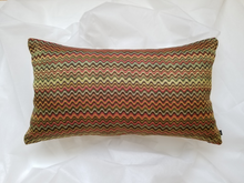 Load image into Gallery viewer, This 14 X 24 inch pillow cover is a retro work of art. This pillow has a rainbow of waves running horizontally across the pillow.  The colour palate resembles a beautiful sunrise with hues of orange, red, green, yellow, and brown.  
